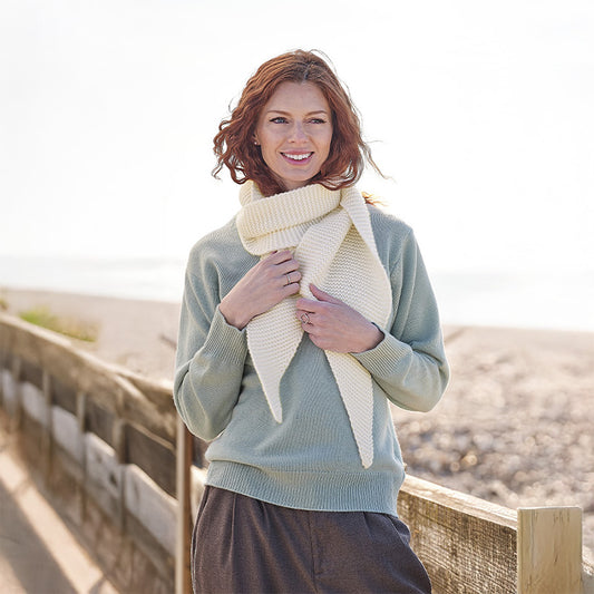 Woman wearing a cream cashmere scarf outdoors