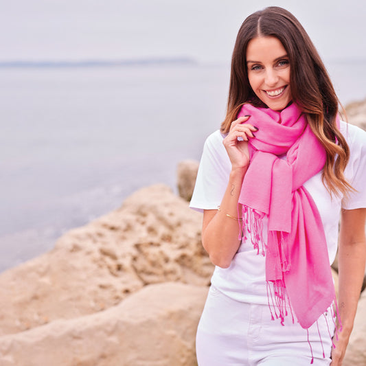 Woman wearing a pink wrap by the water