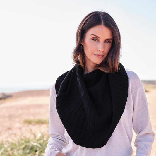 Woman wearing a cashmere black knitted cape outdoors