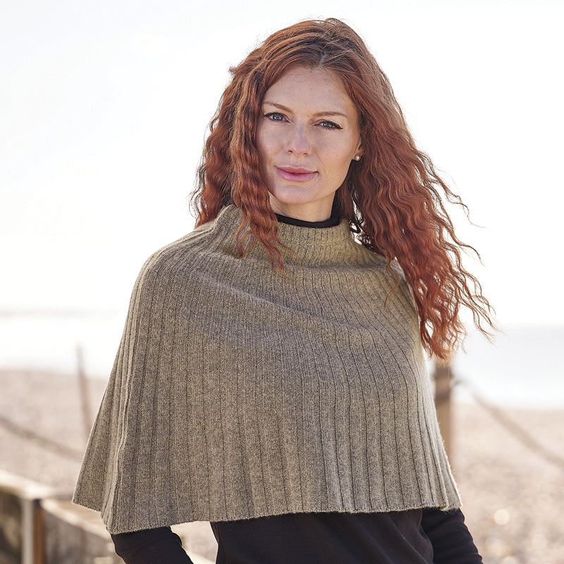 Woman wearing a brown Cashmere knitted cape outdoors