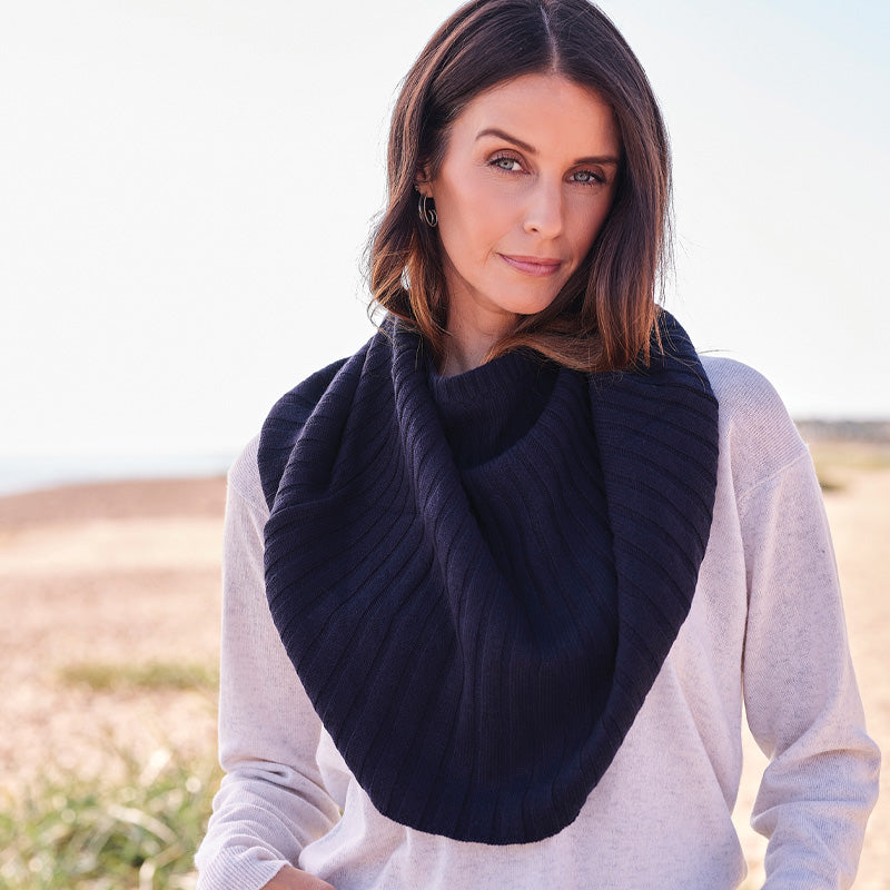Woman wearing a cashmere dark navy knitted cape outdoors