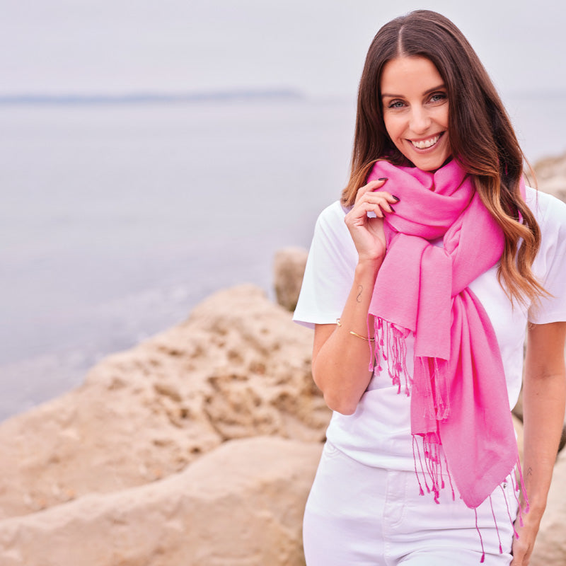 Woman wearing a pink wrap by the water