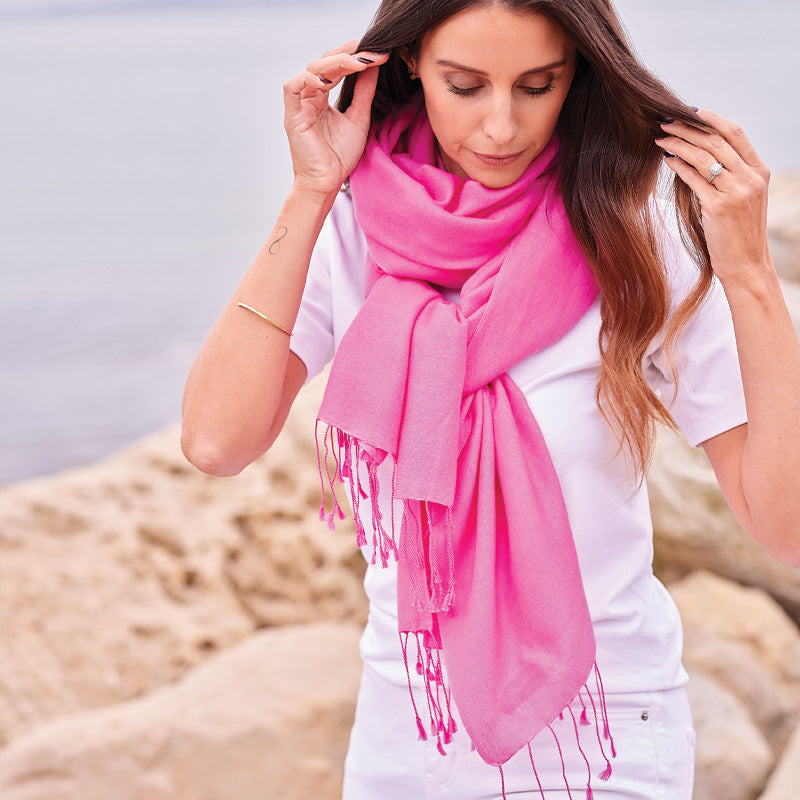 Woman wearing a pink wrap on a beach