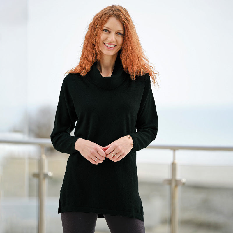 Woman wearing a Cashmere black long-sleeve top with a blurred background
