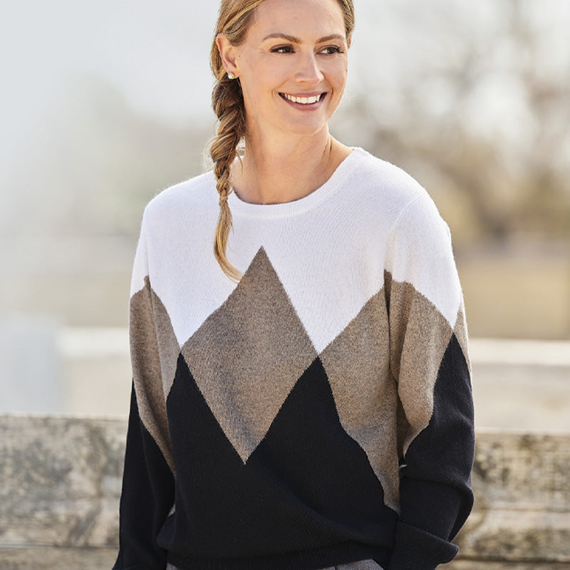 Woman wearing a cashmere black and white patterned sweater outdoors